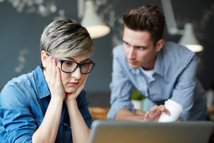 Woman looks at screen at a mistake she made